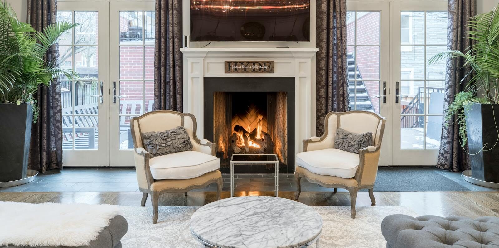 Stylish and contemporary living room featuring a cozy fireplace and elegant furniture.